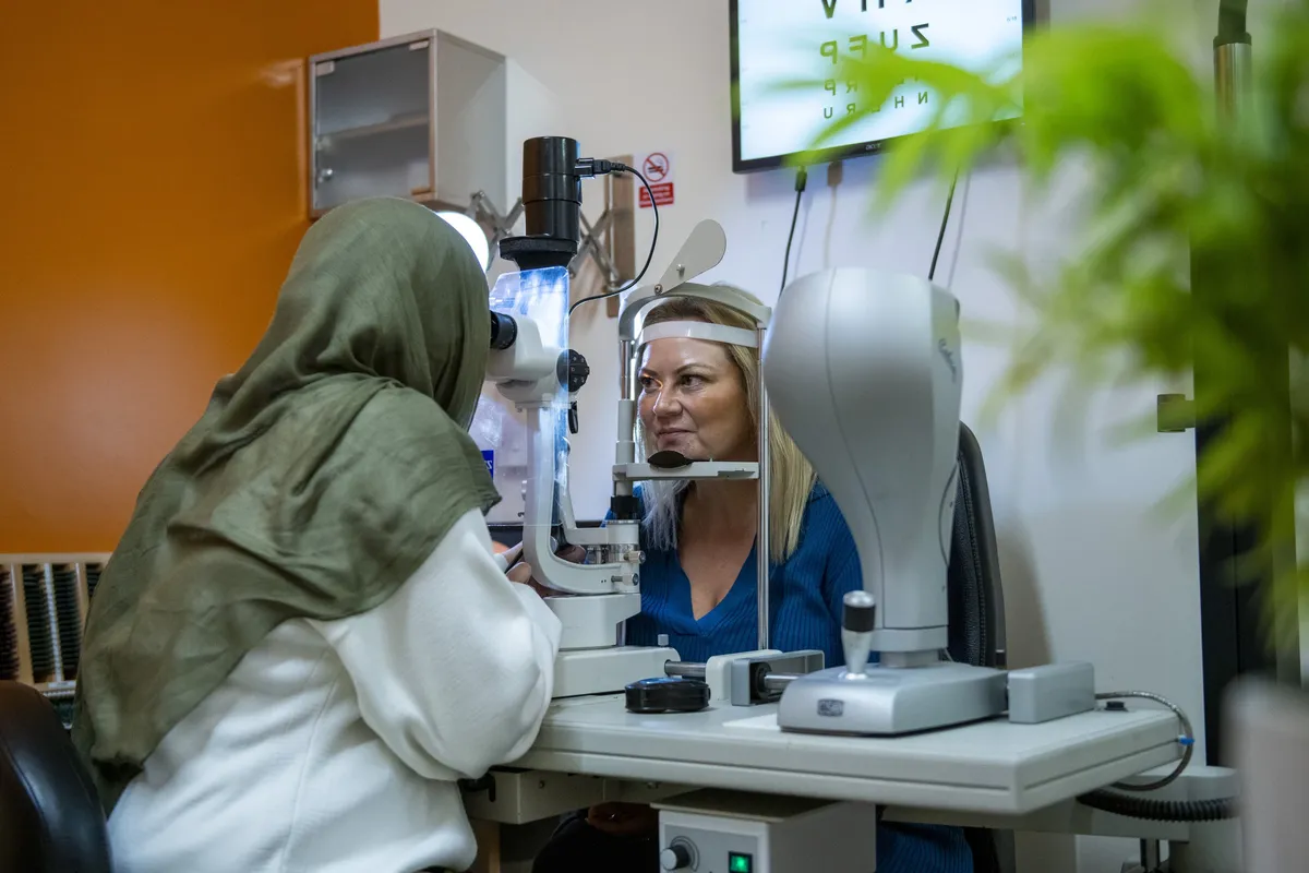 An optometrist examining a patient’s eyes at Norfolk Opticians